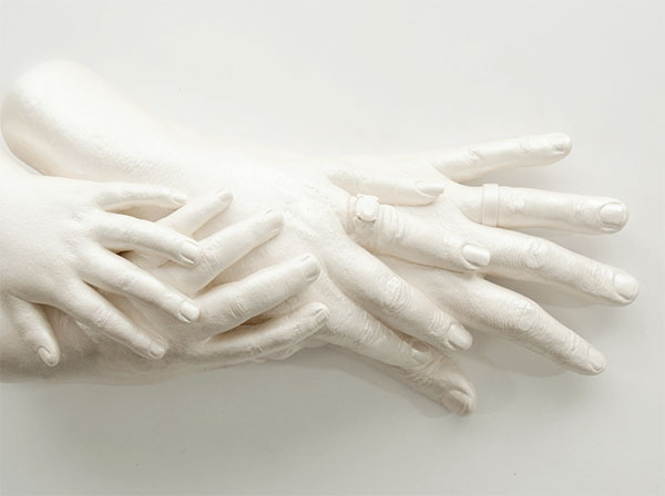 Opal Family Sculpture of four hands piled atop each other